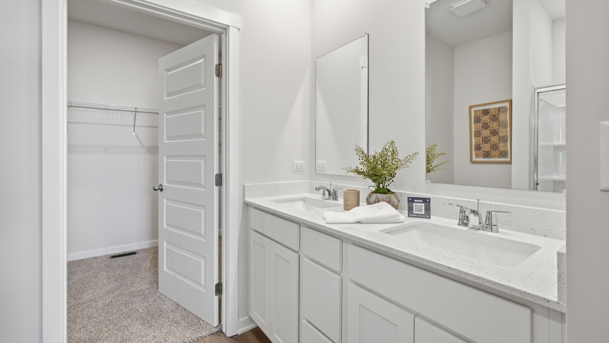 Primary bathroom with dual vanity sinks.