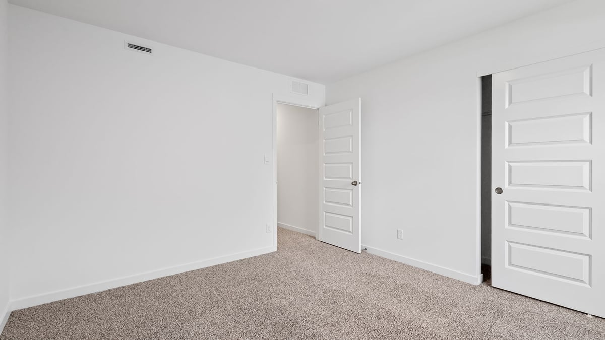 Bedroom with carpeted floors and a closet.