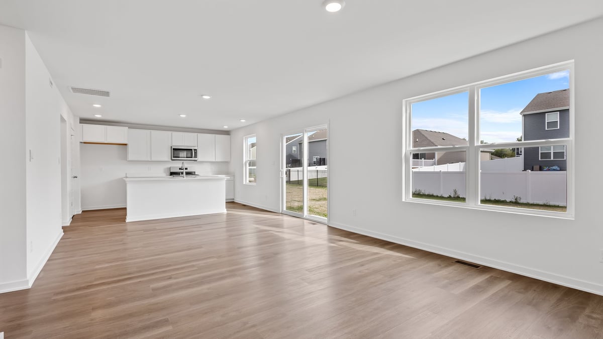 Living room area with a big window and plenty of space.