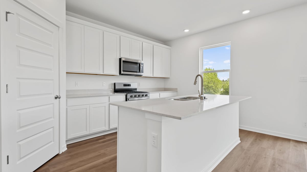 Kitchen area with view of side window in kitchen.