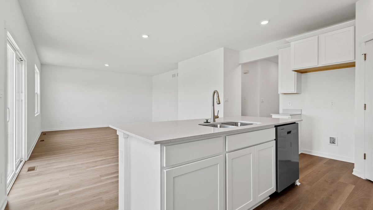 Kitchen island with hard wood flooring and great space.
