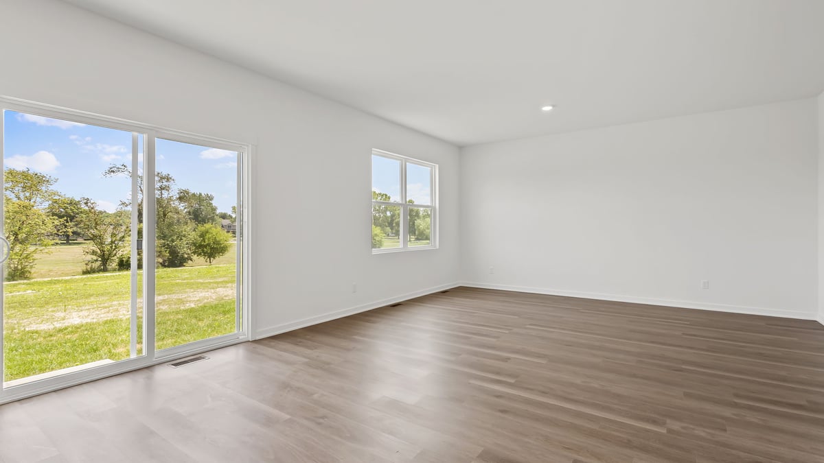 Dining room area and living room space with glass sliding door.