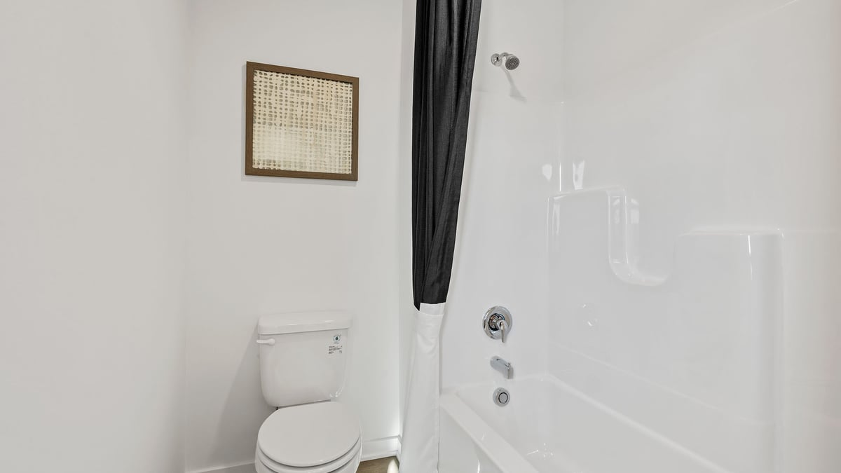 Toilet and shower in bathroom.