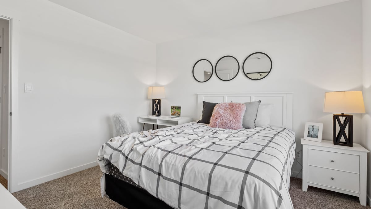 Bedroom staged as a teenage girl room with carpet and a closet.