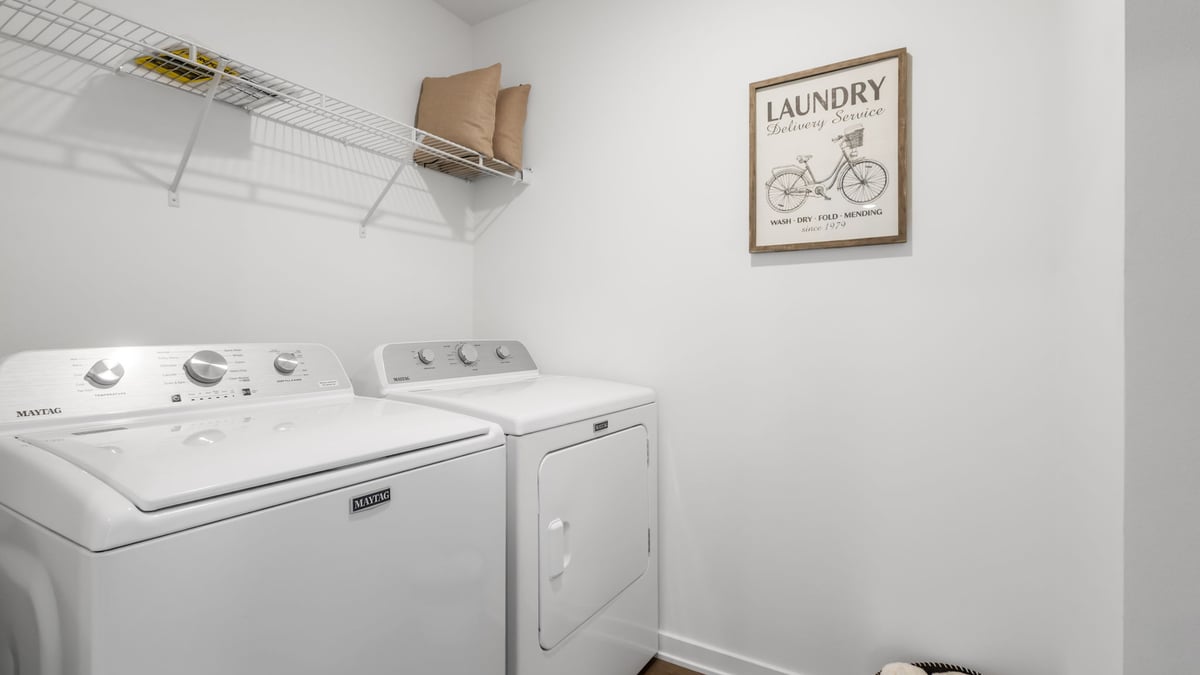 Laundry room with storage space.