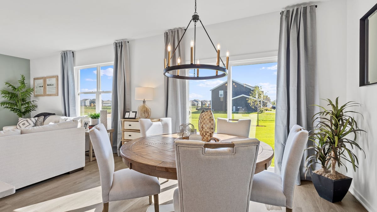 Dining area with a glass sliding door and windows.