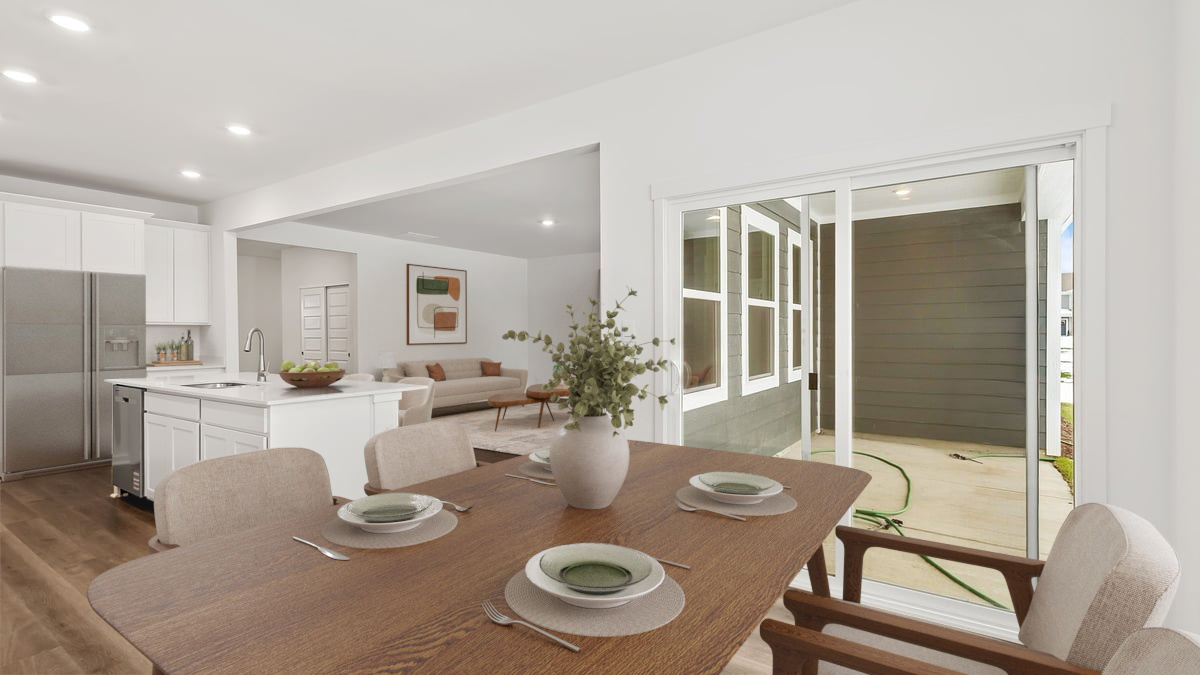 Dining area with a glass sliding door and a seamless layout.