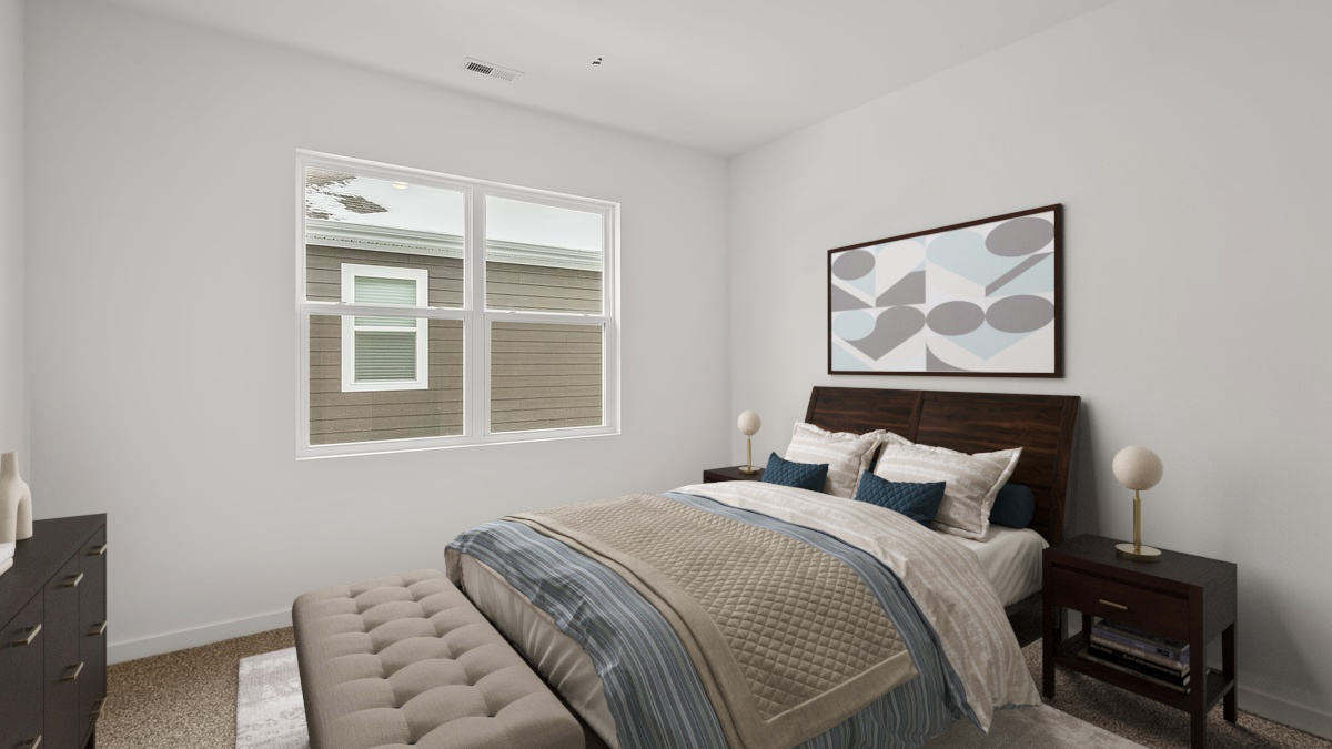 Bedroom with carpeted floors and a big window.