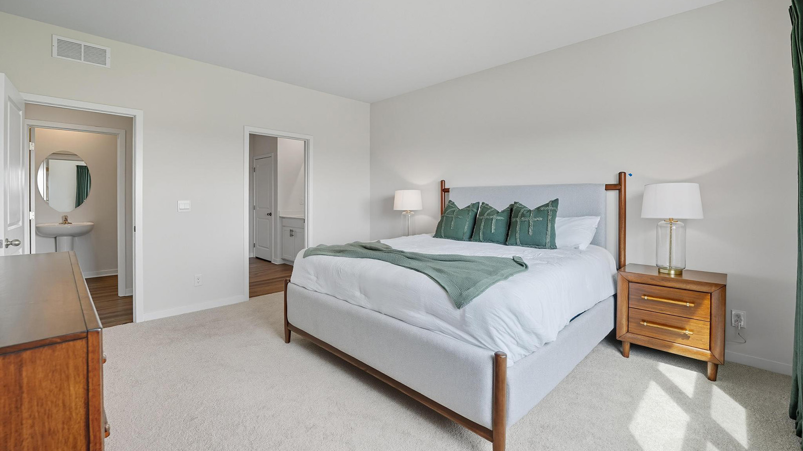 Primary carpeted bedroom with large windows