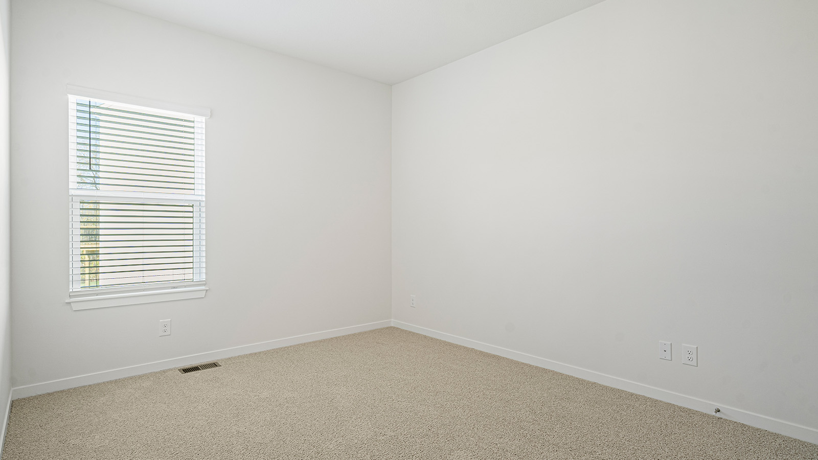 Carpeted bedroom with window