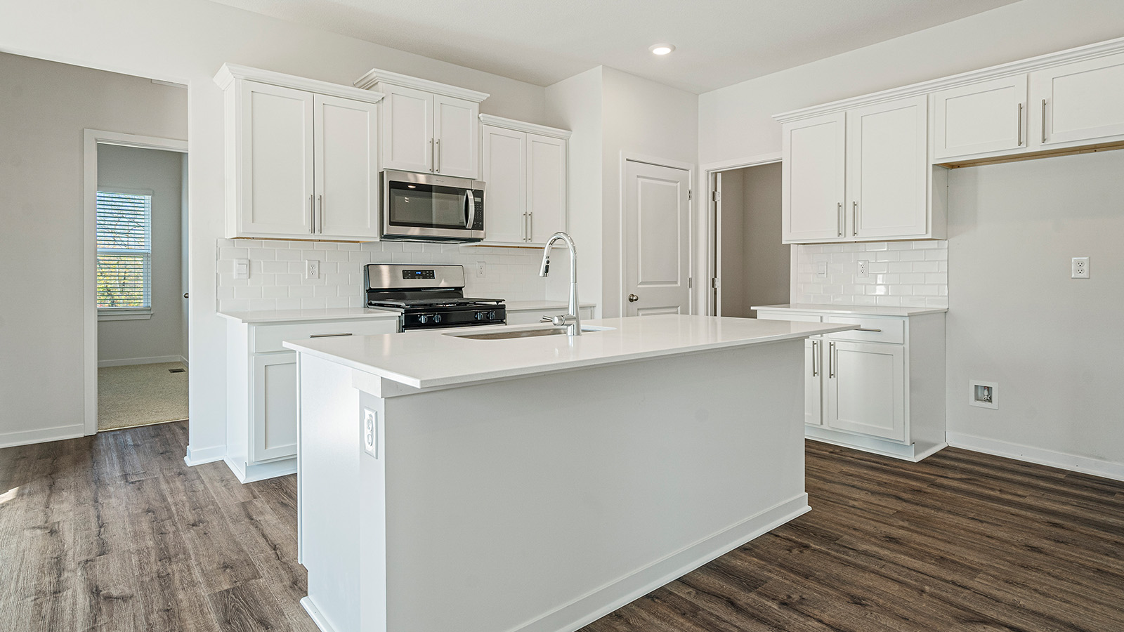 Kitchen with large Island, white cabinets and countertops