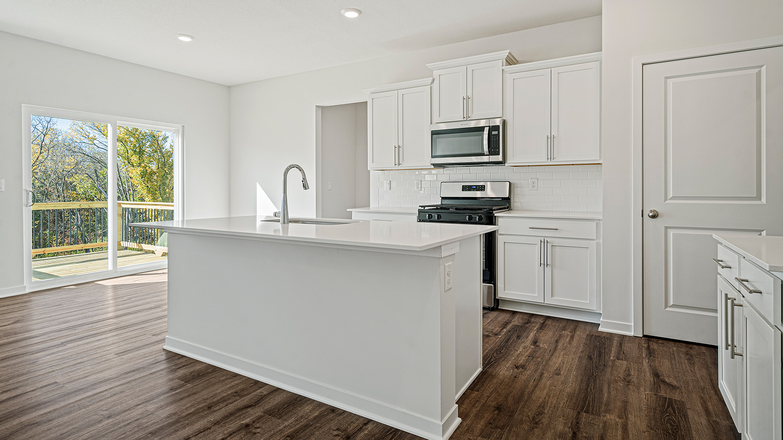 Kitchen with large Island, white cabinets and countertops