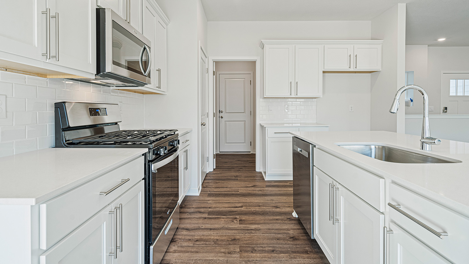 Kitchen with large Island, white cabinets and countertops