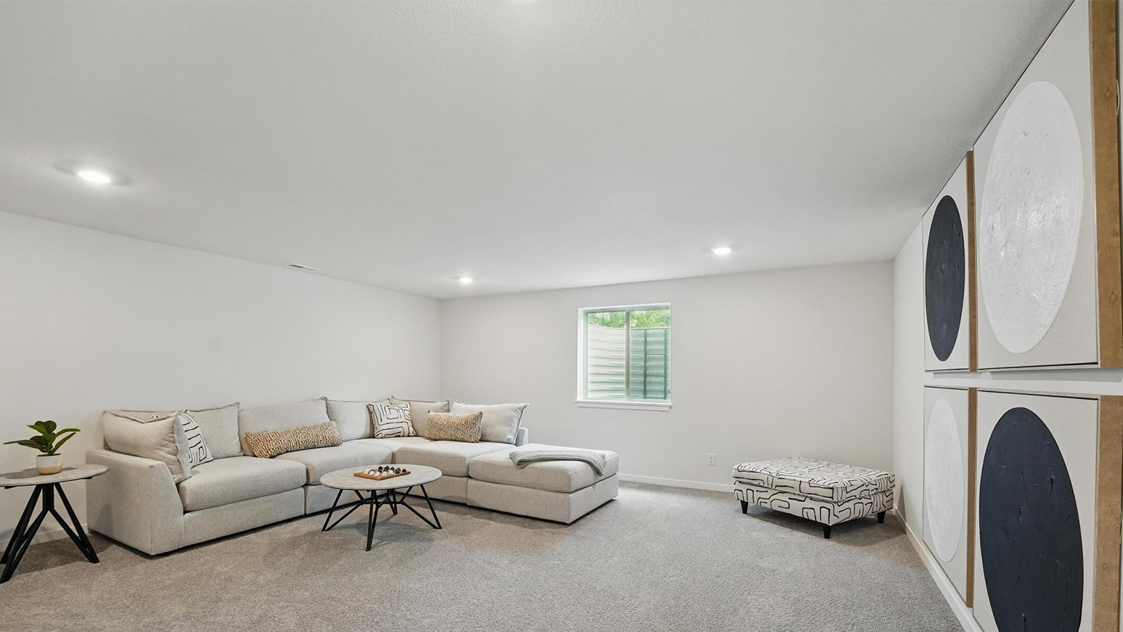 carpeted basement with large window
