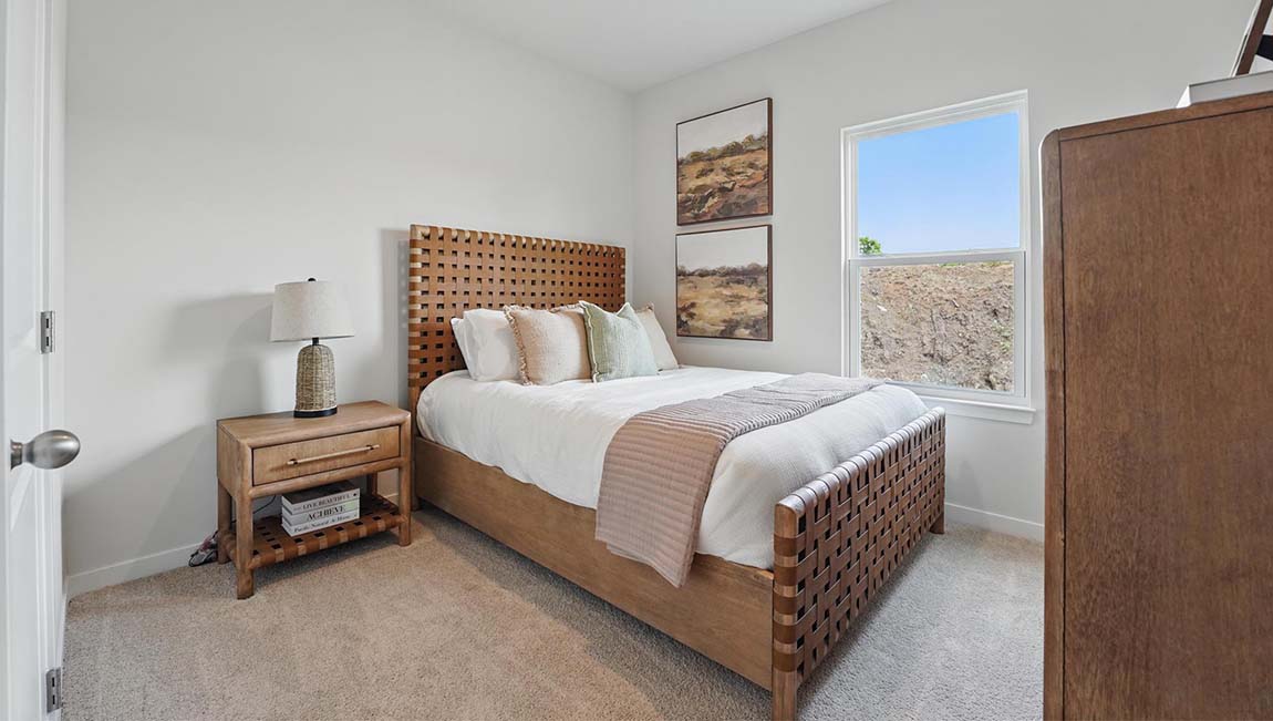 Carpeted bedroom with large windows
