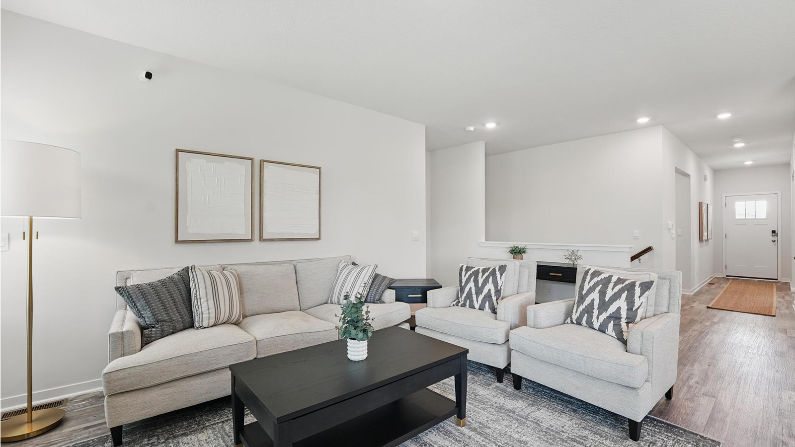 open concept living area with electric fireplace and large windows