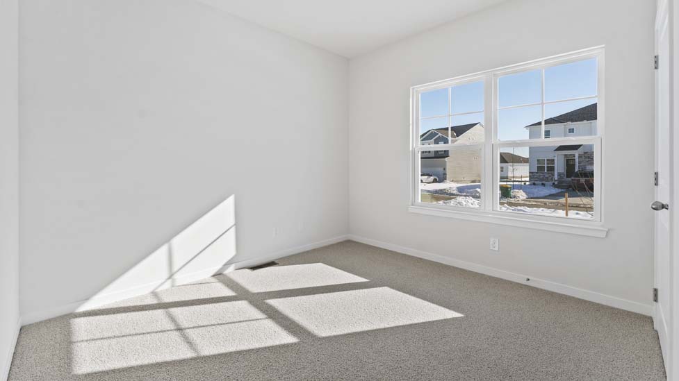 Carpeted bedroom with large window