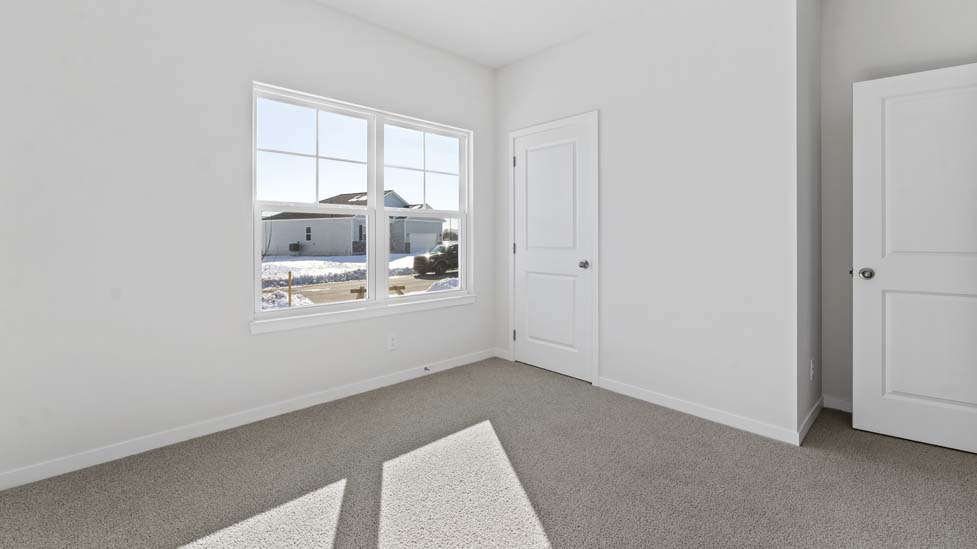 Carpeted bedroom with large window