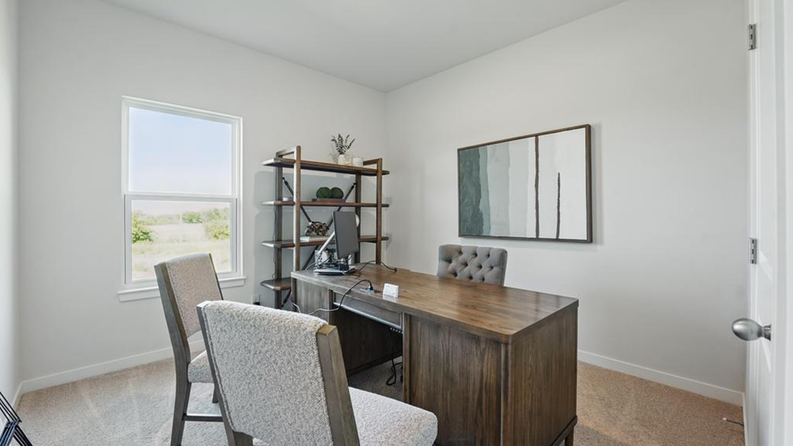 Carpeted bedroom used as office with large window