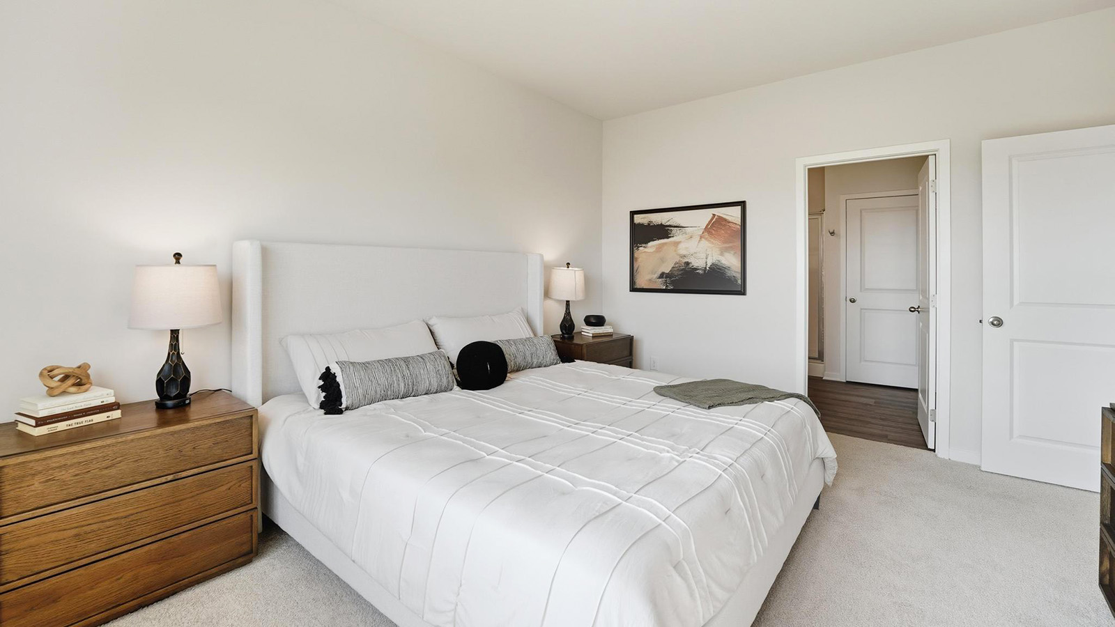Primary bedroom with carpet, and two large windows