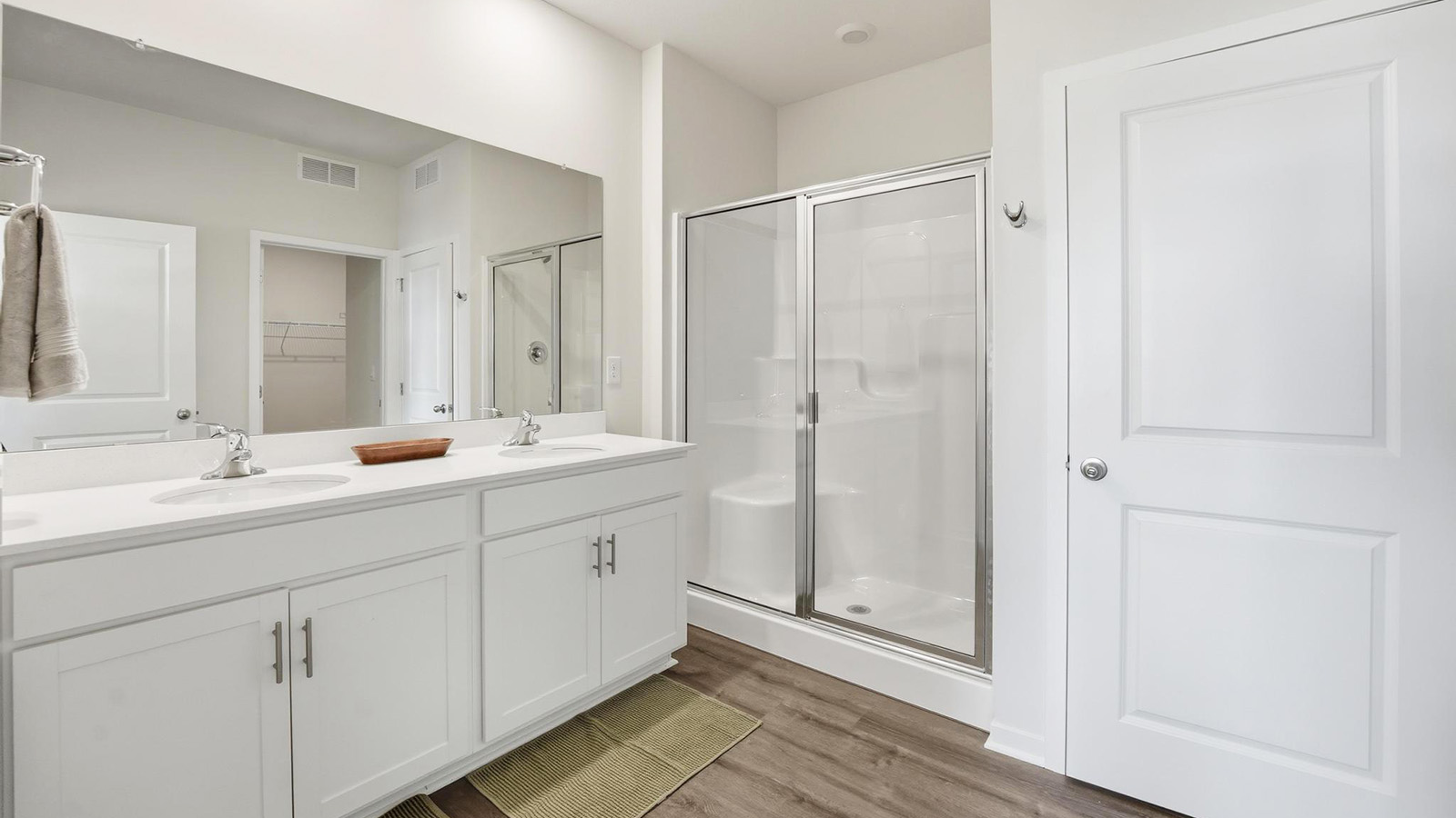 Bathroom with double vanity and shower with glass door