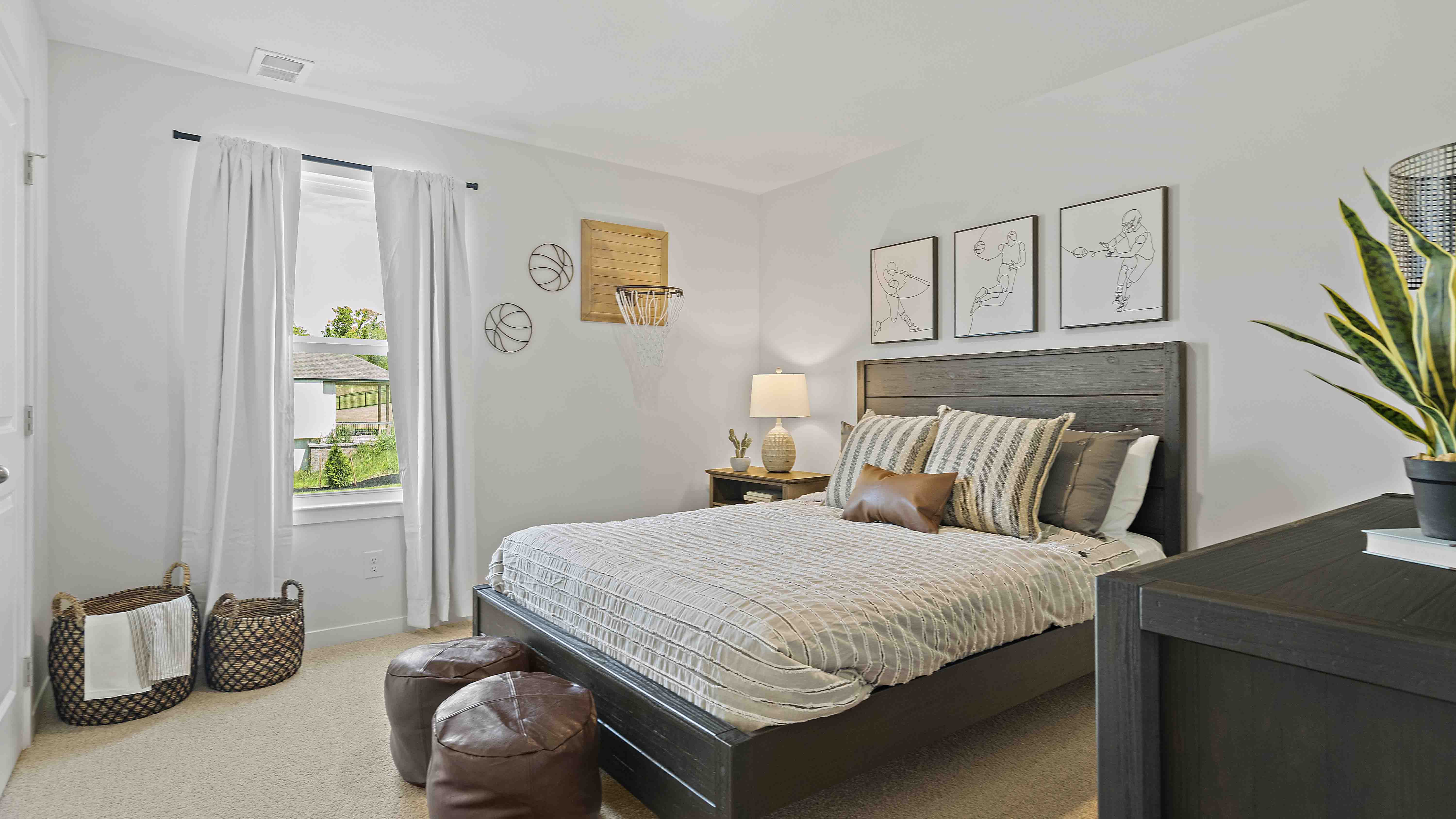 Carpeted bedroom with large window.