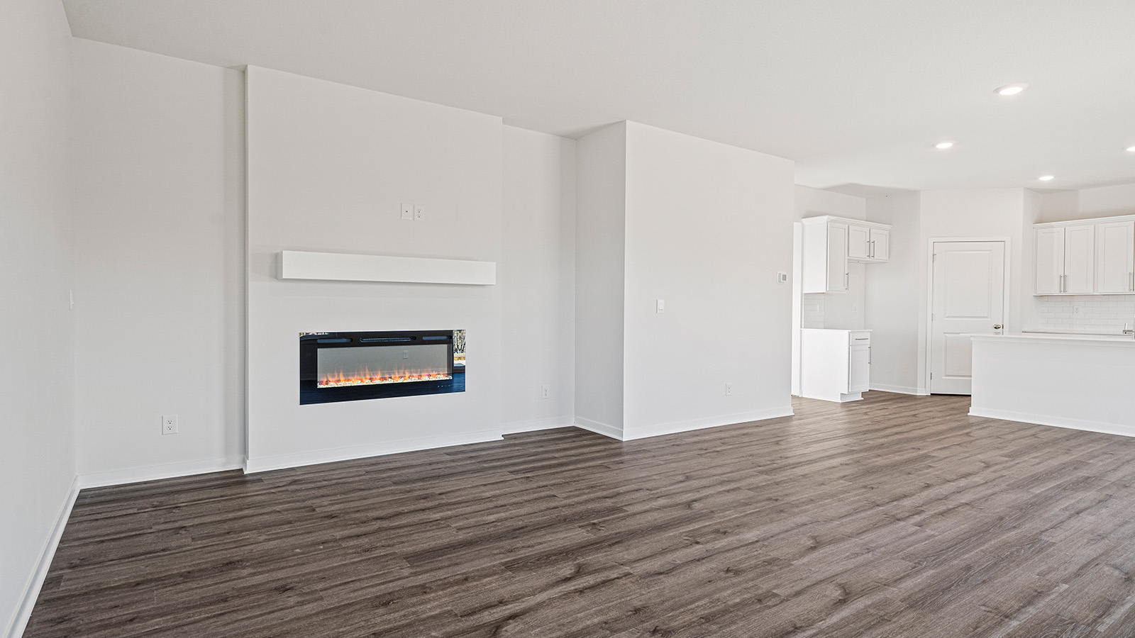 Open concept living area with electric fireplace and large window