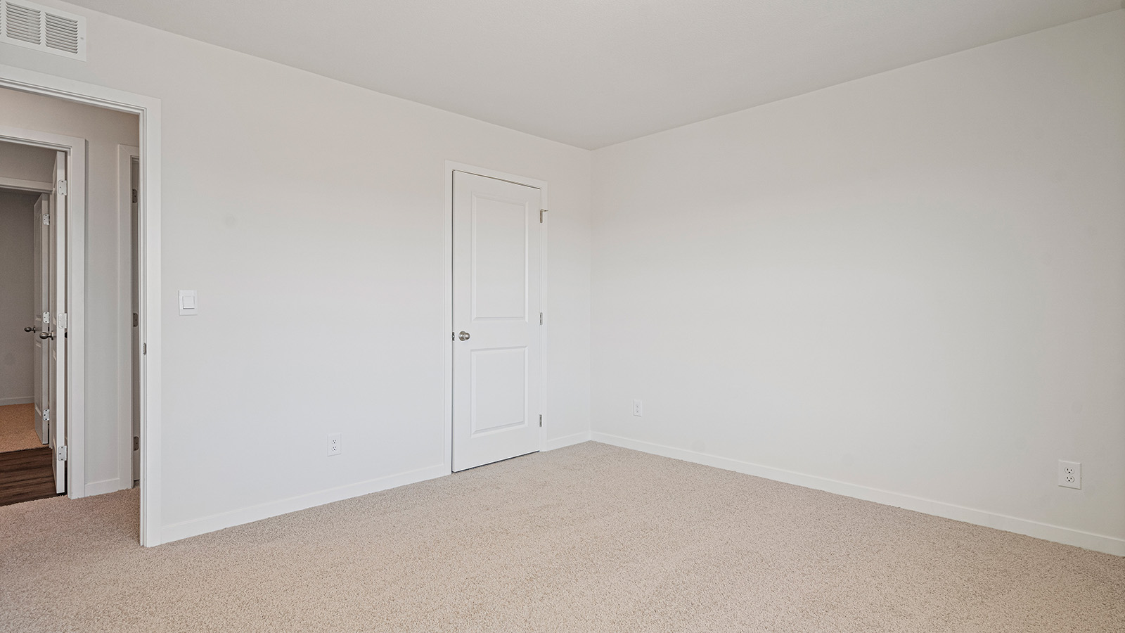 Carpeted bedroom with large window