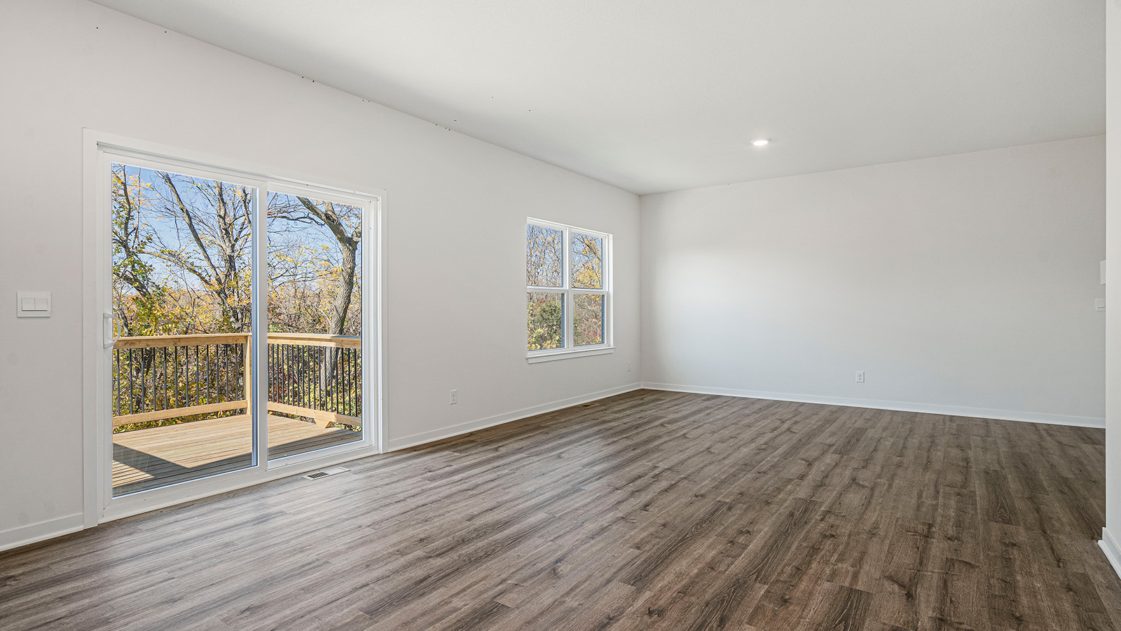 Open concept living area with electric fireplace and large window
