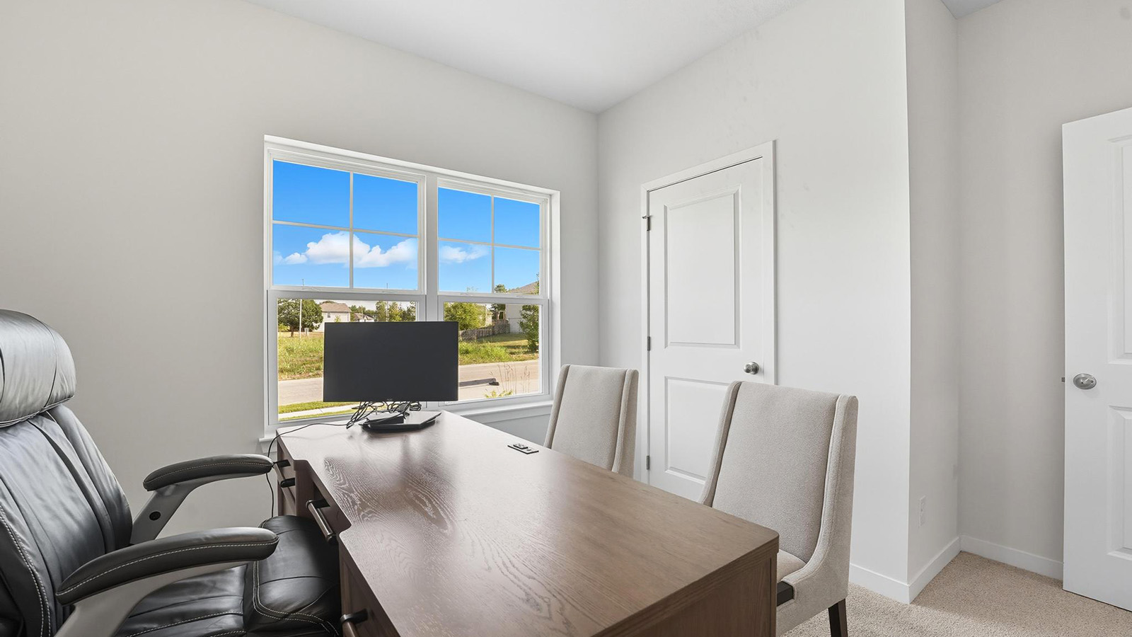 Bedroom or office space with large window.