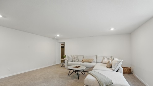 Carpeted upstairs loft area with large window