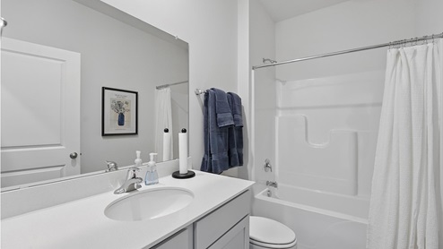 Bathroom with bathtub and shower combination. New Homes in Kansas City, Missouri