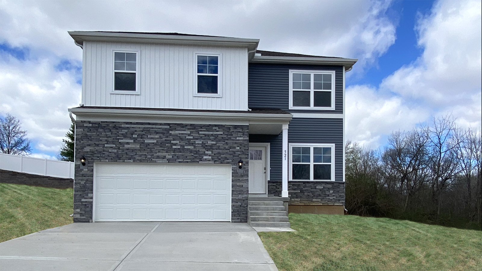 Holcombe front exterior with beige siding and garage