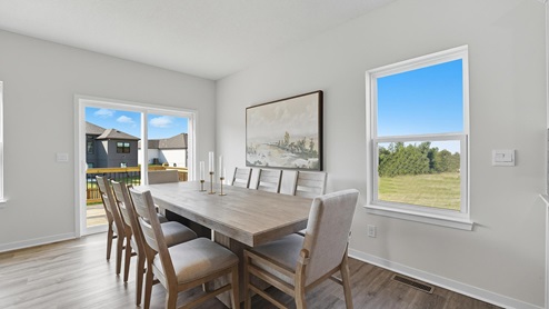 Dining area beside kitchen and living room with sliding glass back door and small window