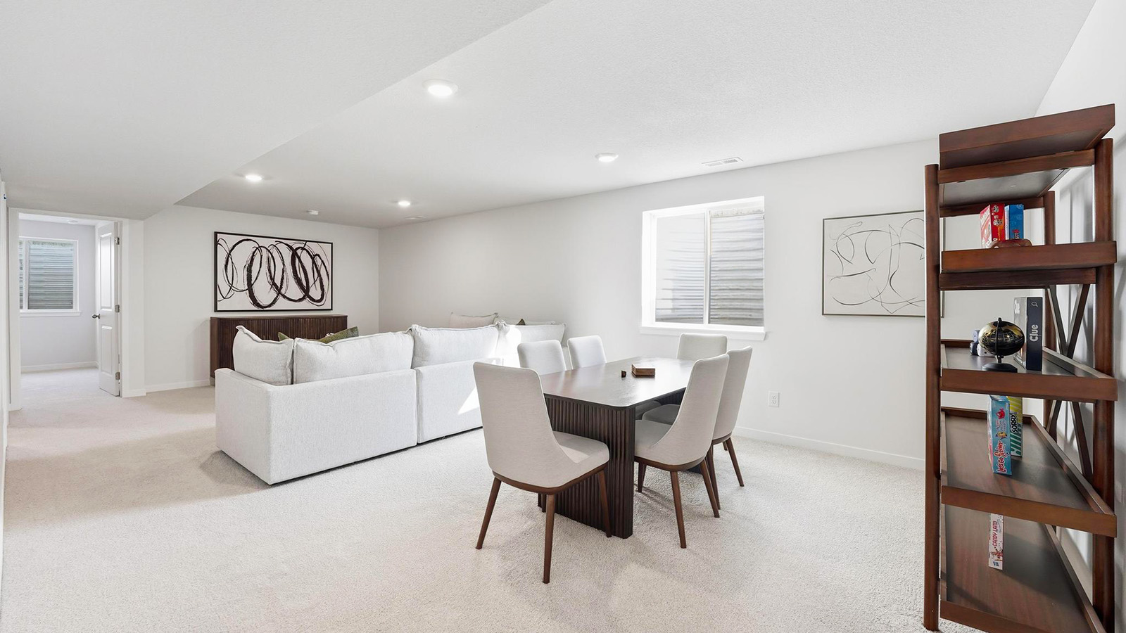 Carpeted basement rec area with large window