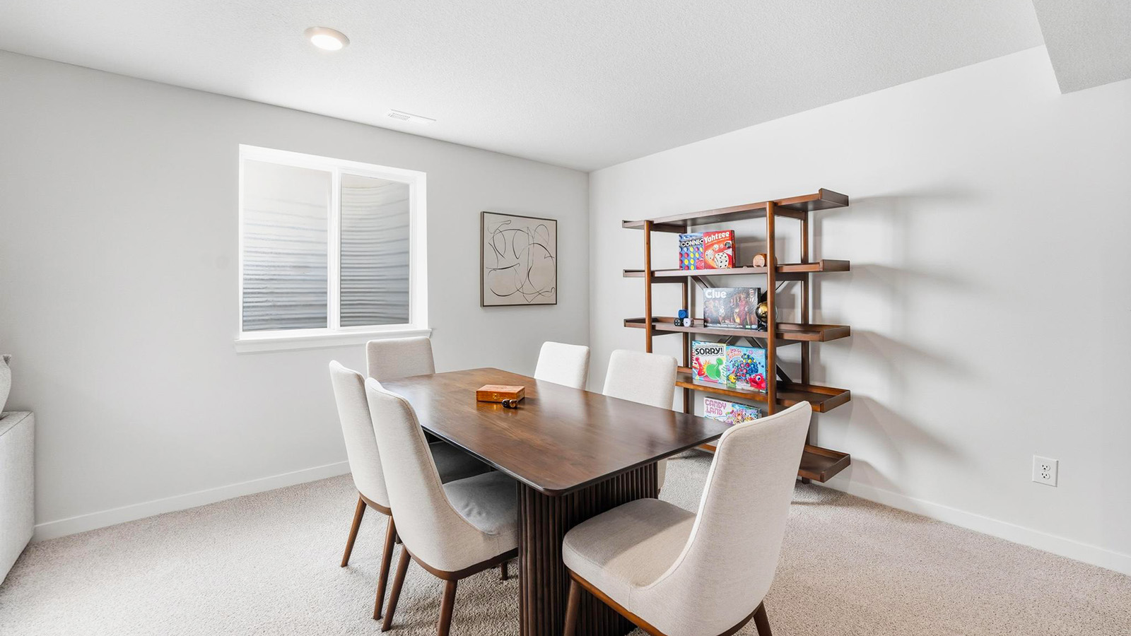 Carpeted basement rec area with large window
