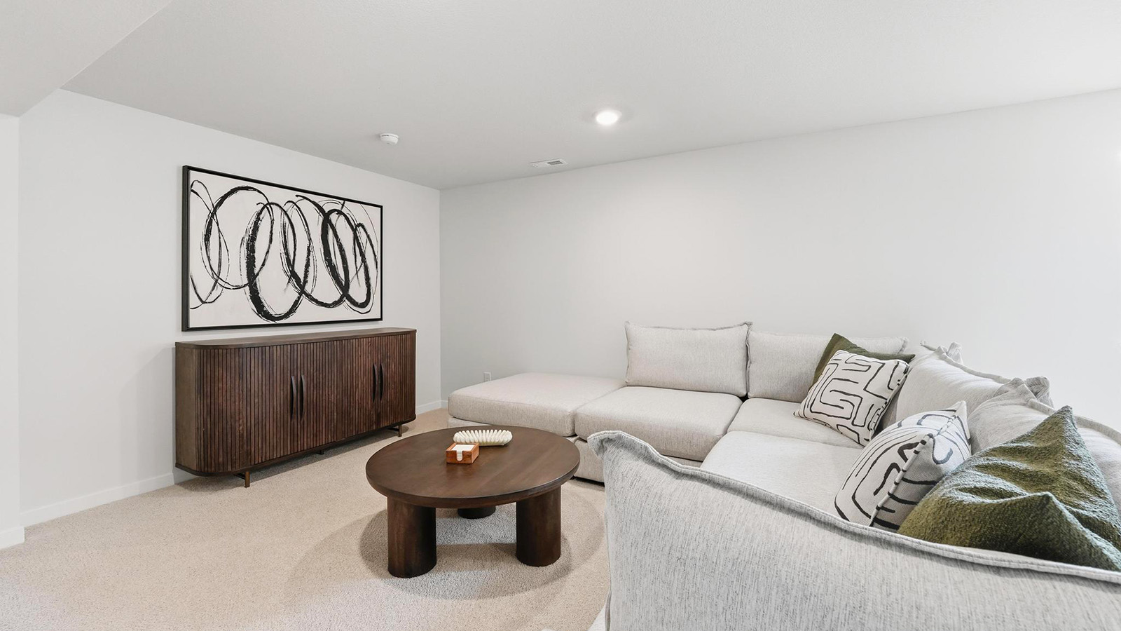 Carpeted basement rec area with large window