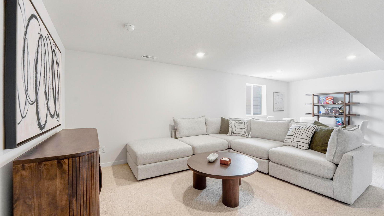 Carpeted basement rec area with large window