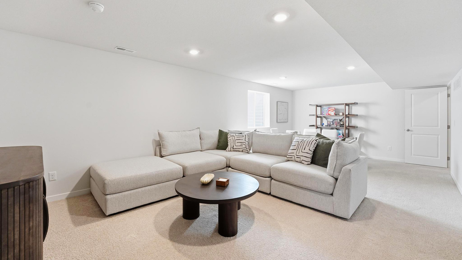 Carpeted basement rec area with large window