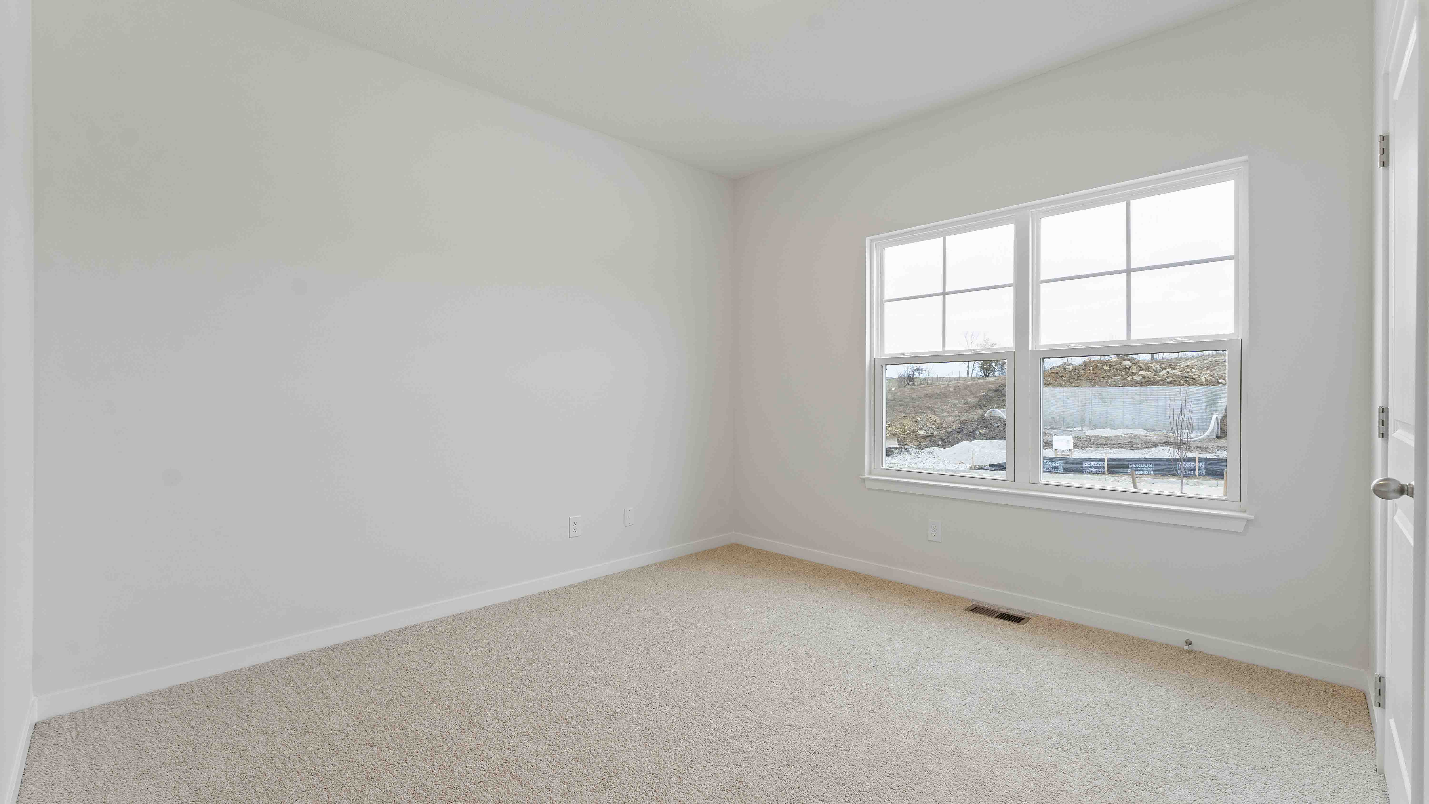 Carpeted bedroom with large window