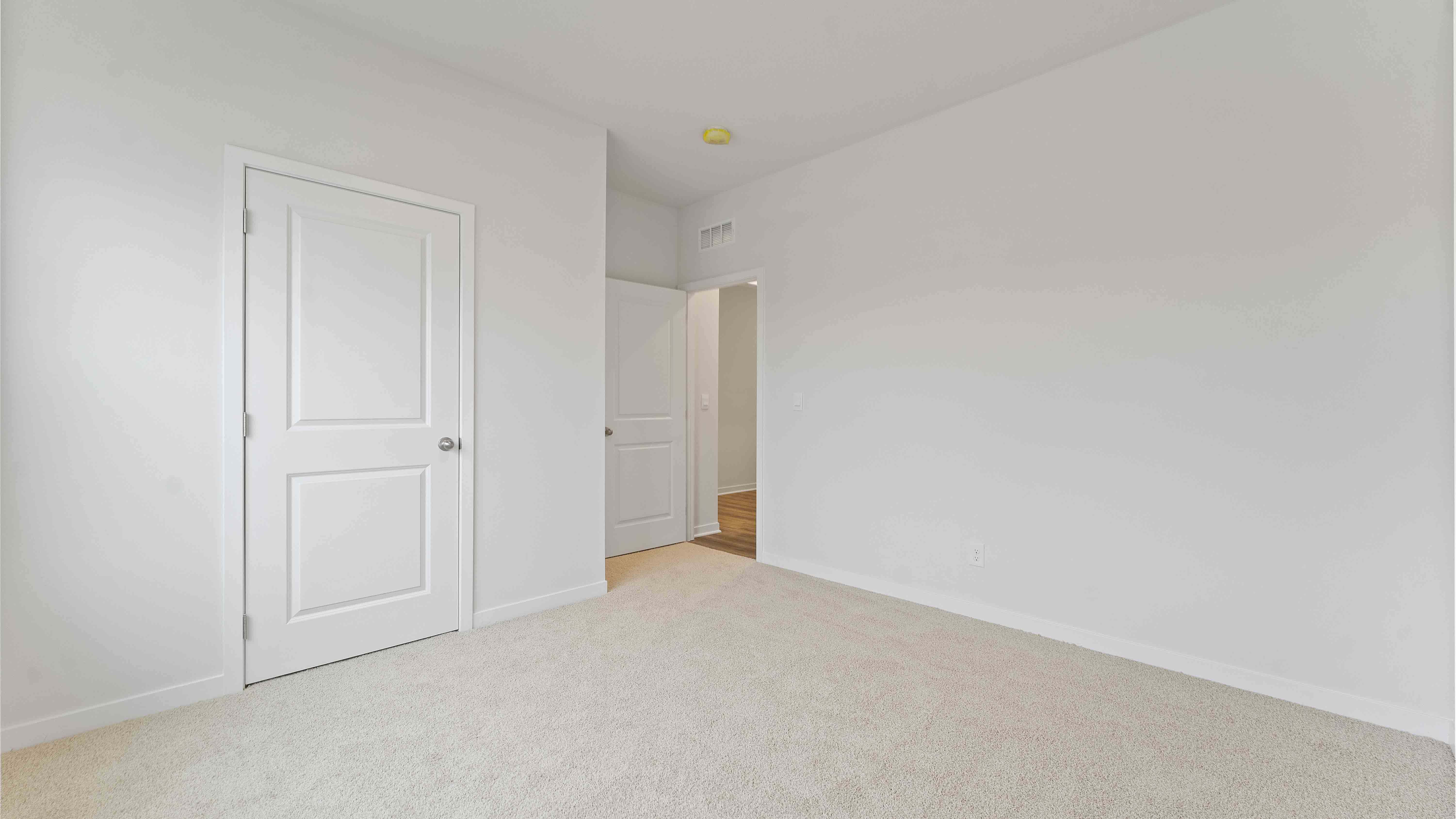 Carpeted bedroom with large window