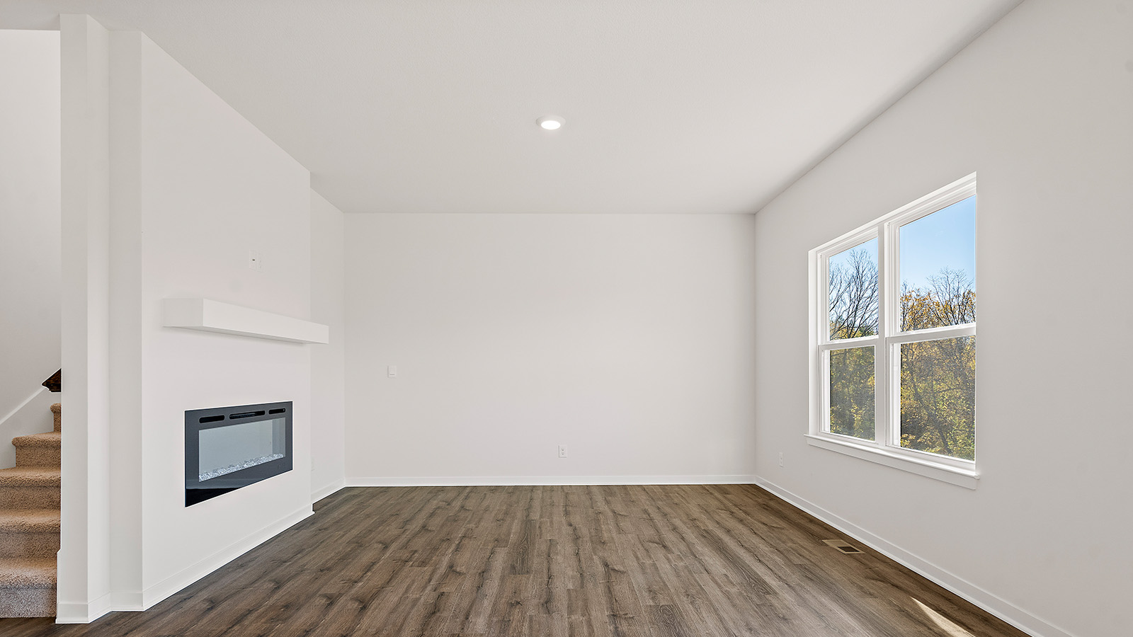 Living room with electric fireplace. New Homes in Kansas City, Missouri