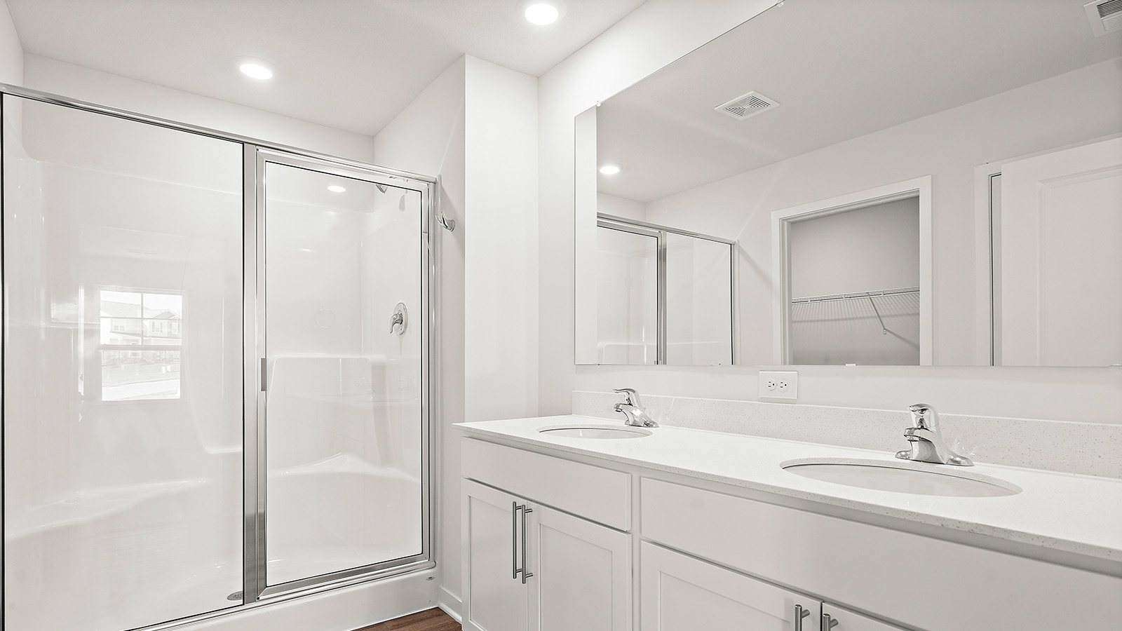 Primary bathroom with standing glass Door shower. New Homes in Kansas City, Missouri