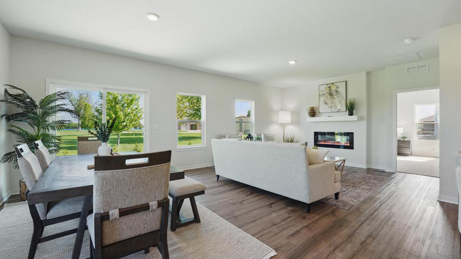 Dining area beside kitchen and living room with sliding glass back door and small window
