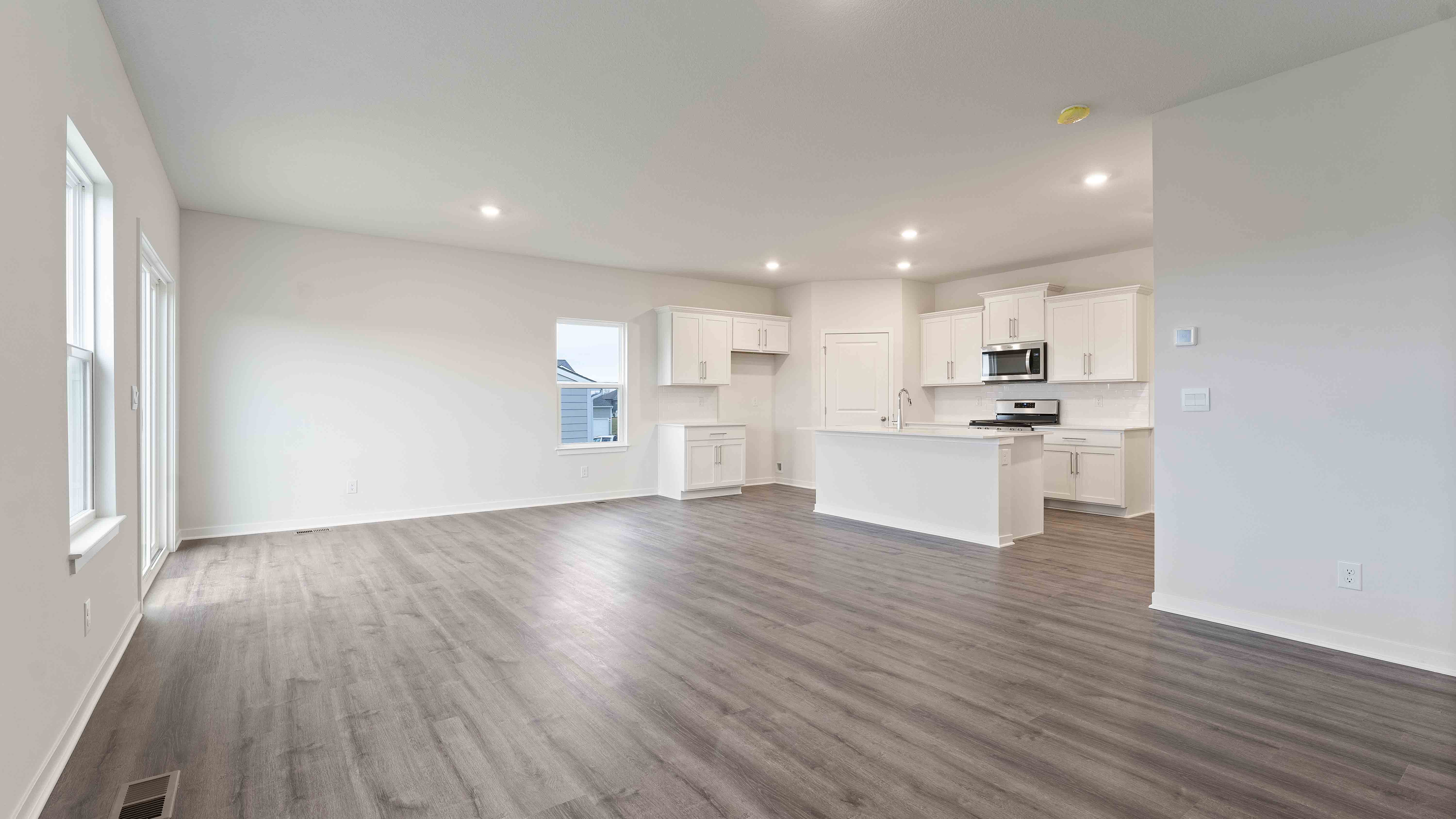 Open concept living area with large windows and fireplace