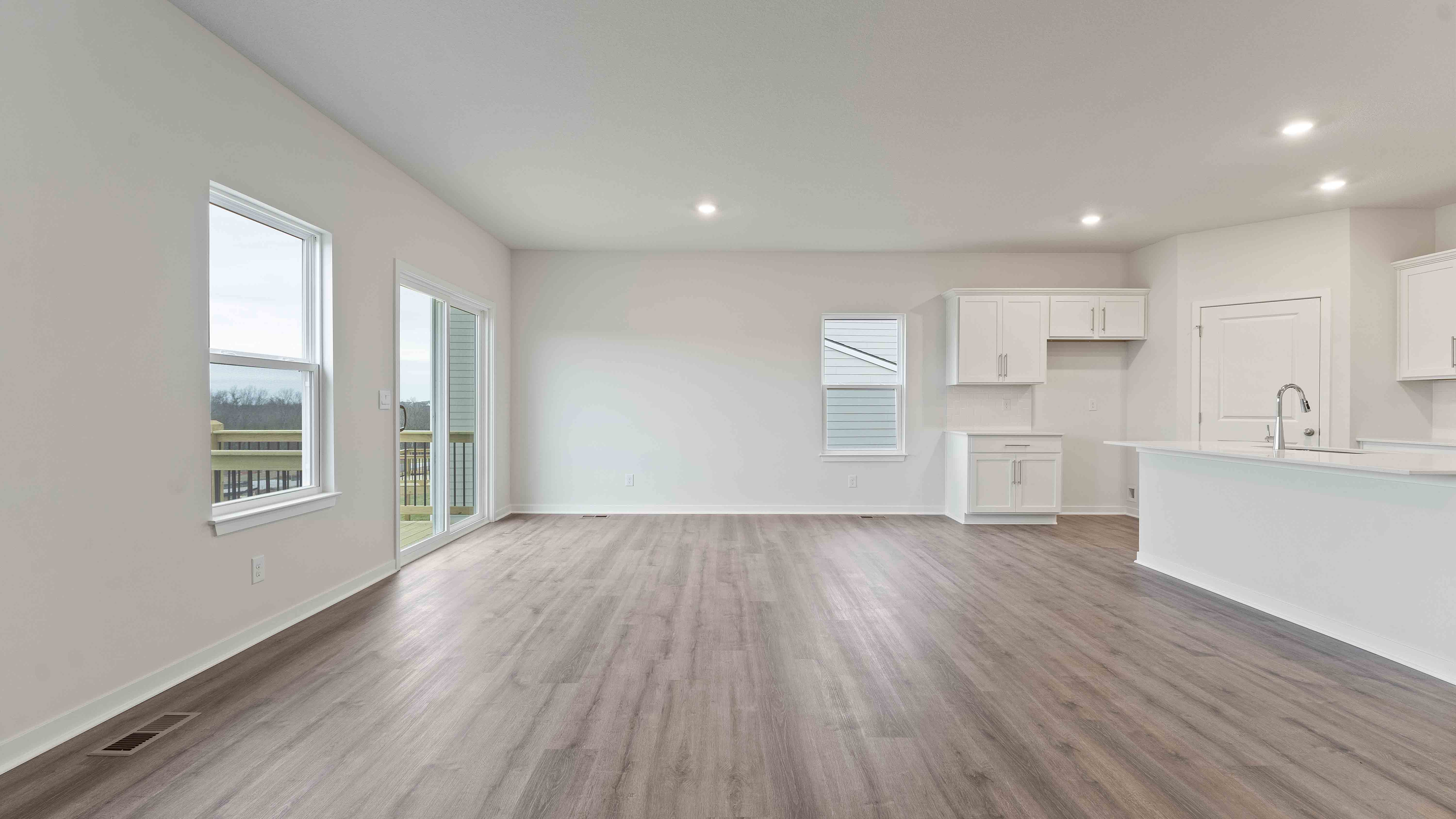 Open concept living area with large windows and fireplace