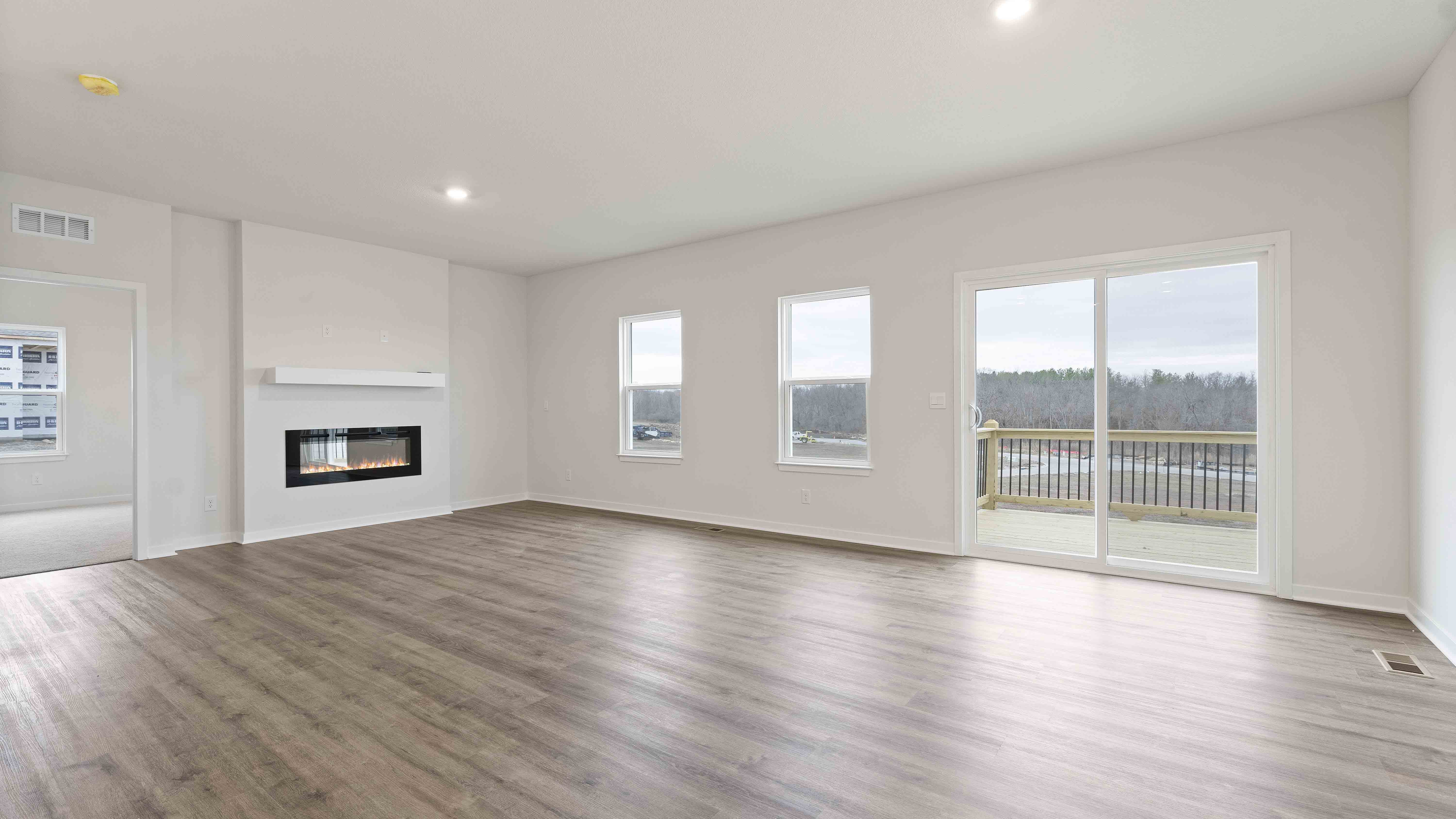 Open concept living area with large windows and fireplace
