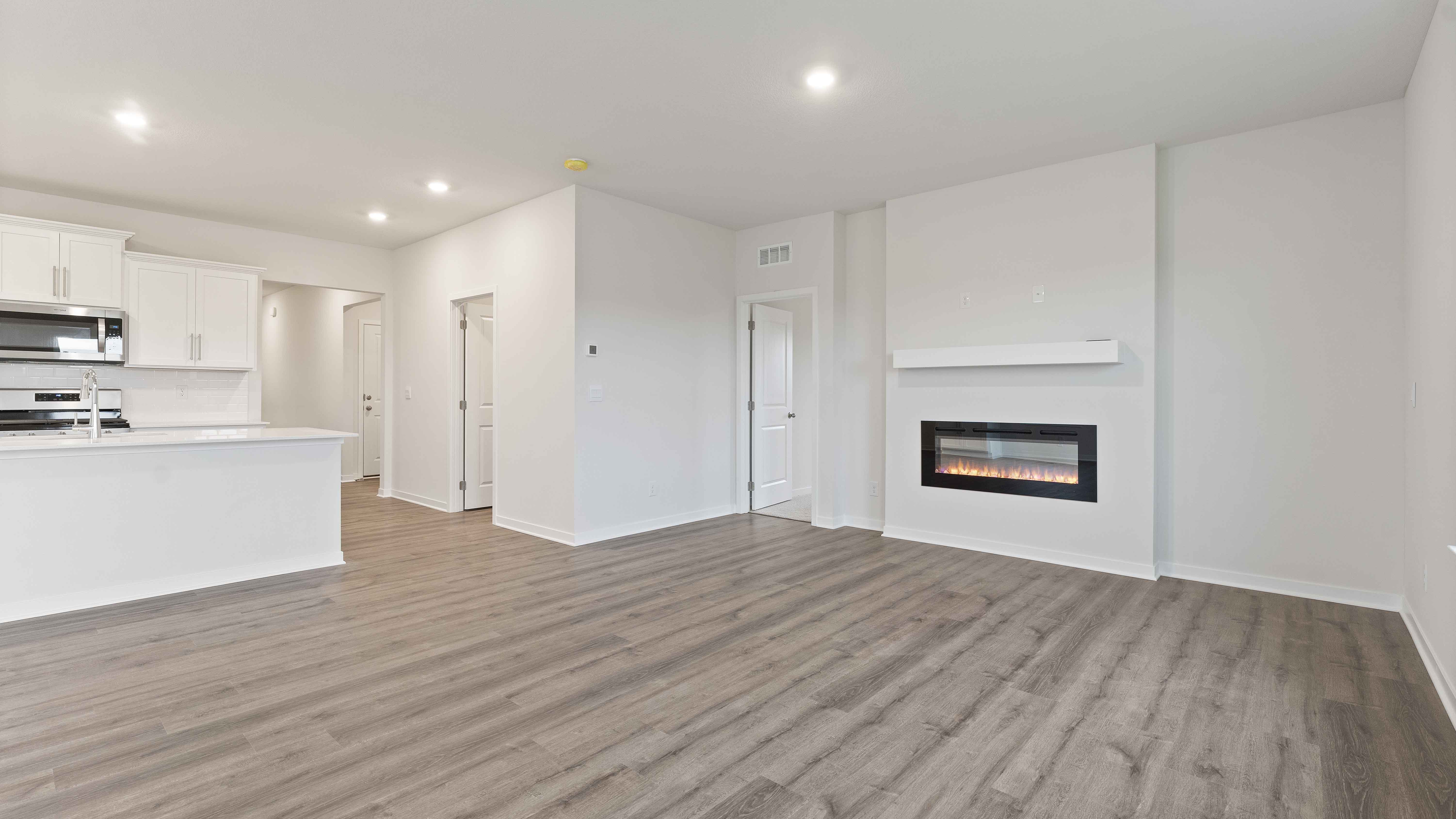 Open concept living area with large windows and fireplace