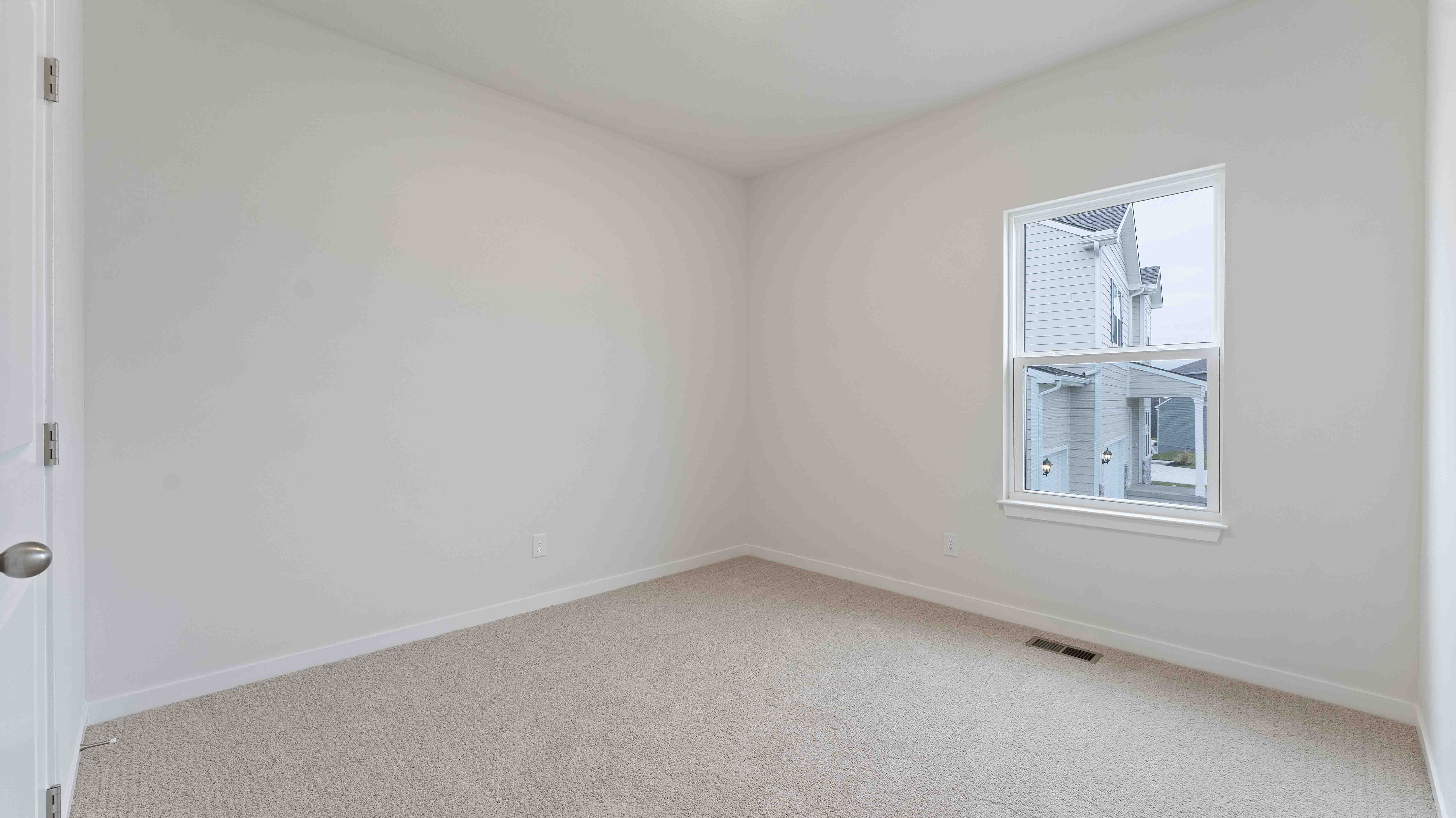 Carpeted bedroom with large window