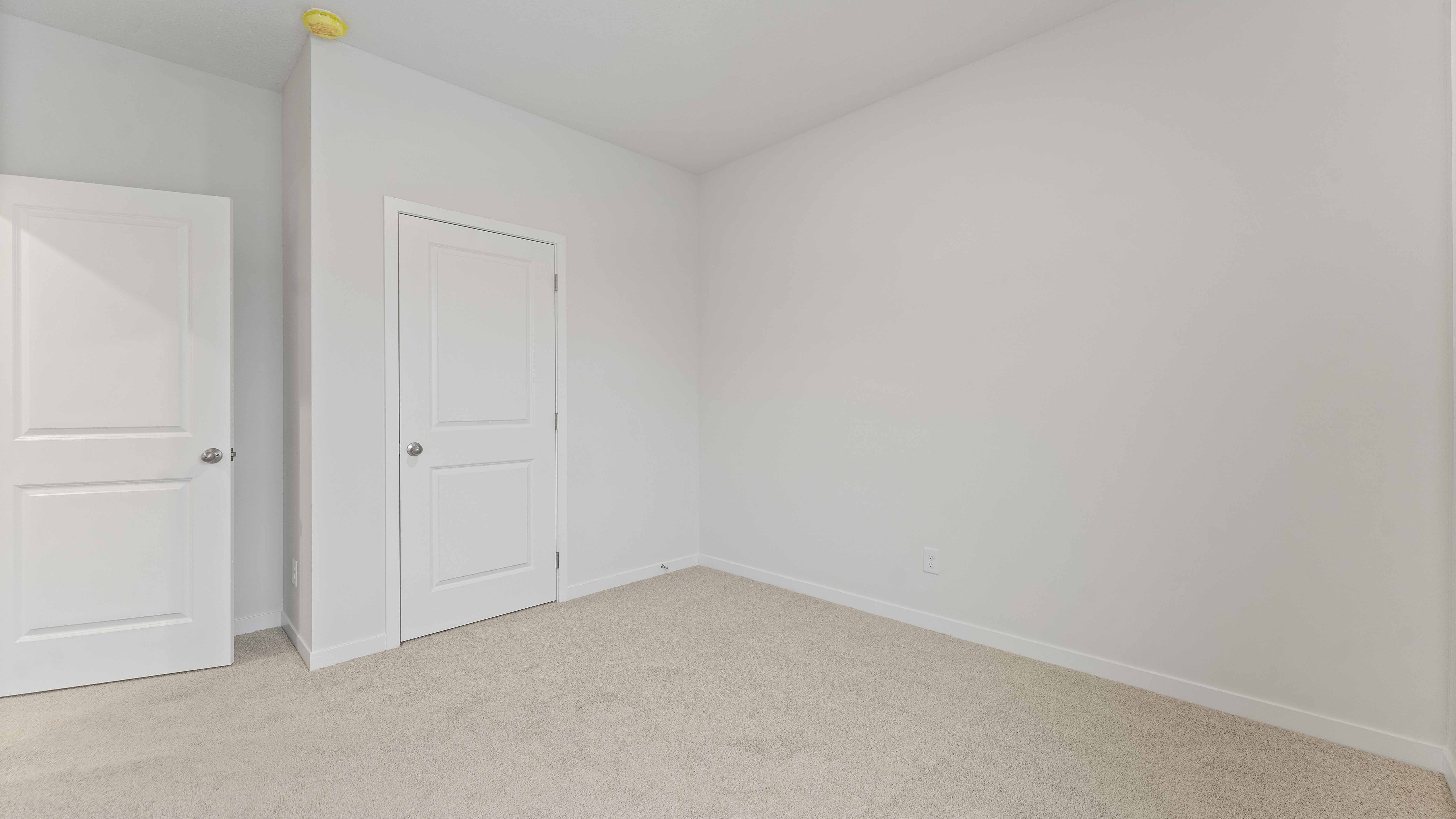 Carpeted bedroom with large window